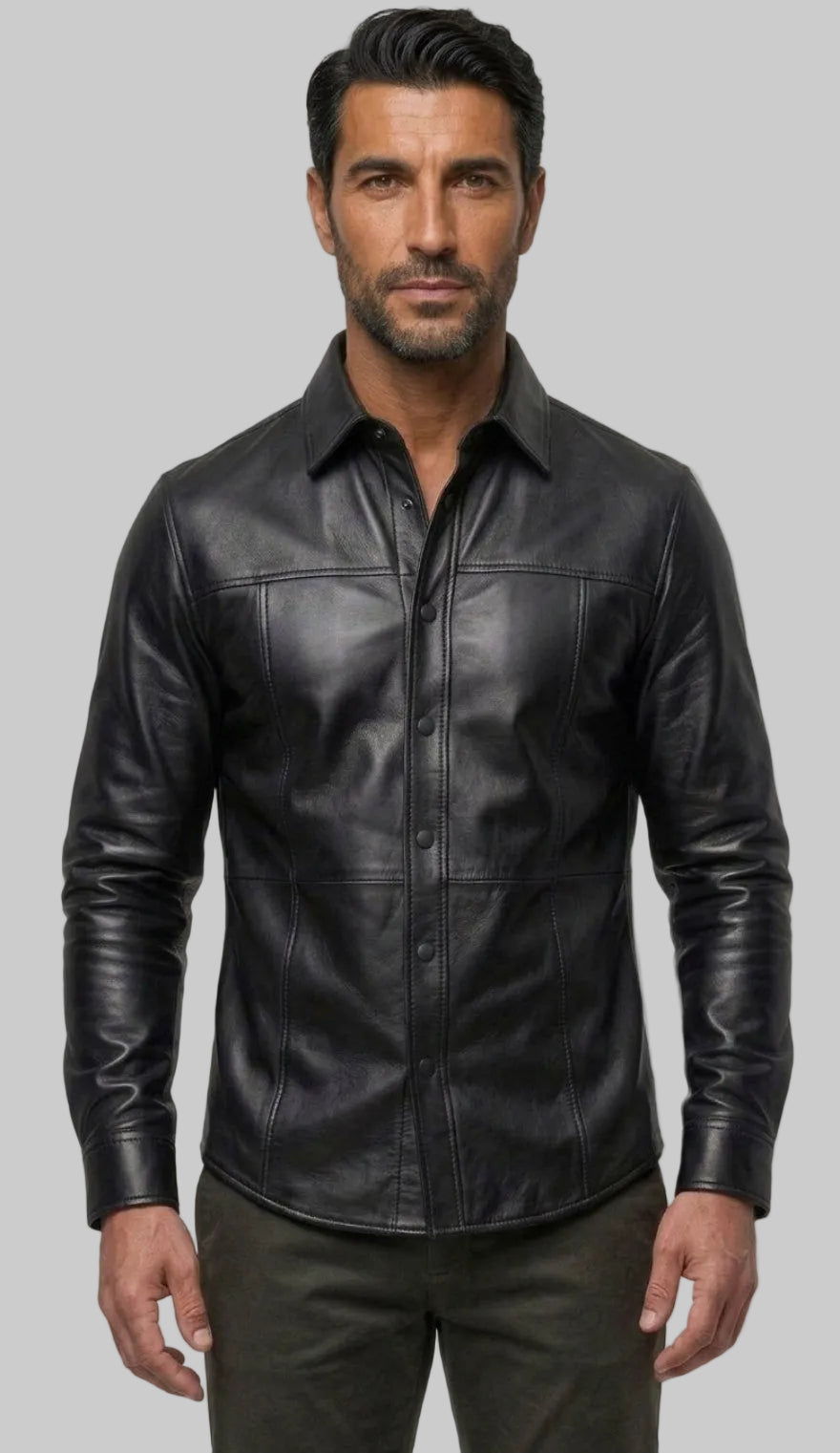 A man wearing our Black Custom Leather Shirt for Men with a collar and front buttons, paired with dark trousers, 