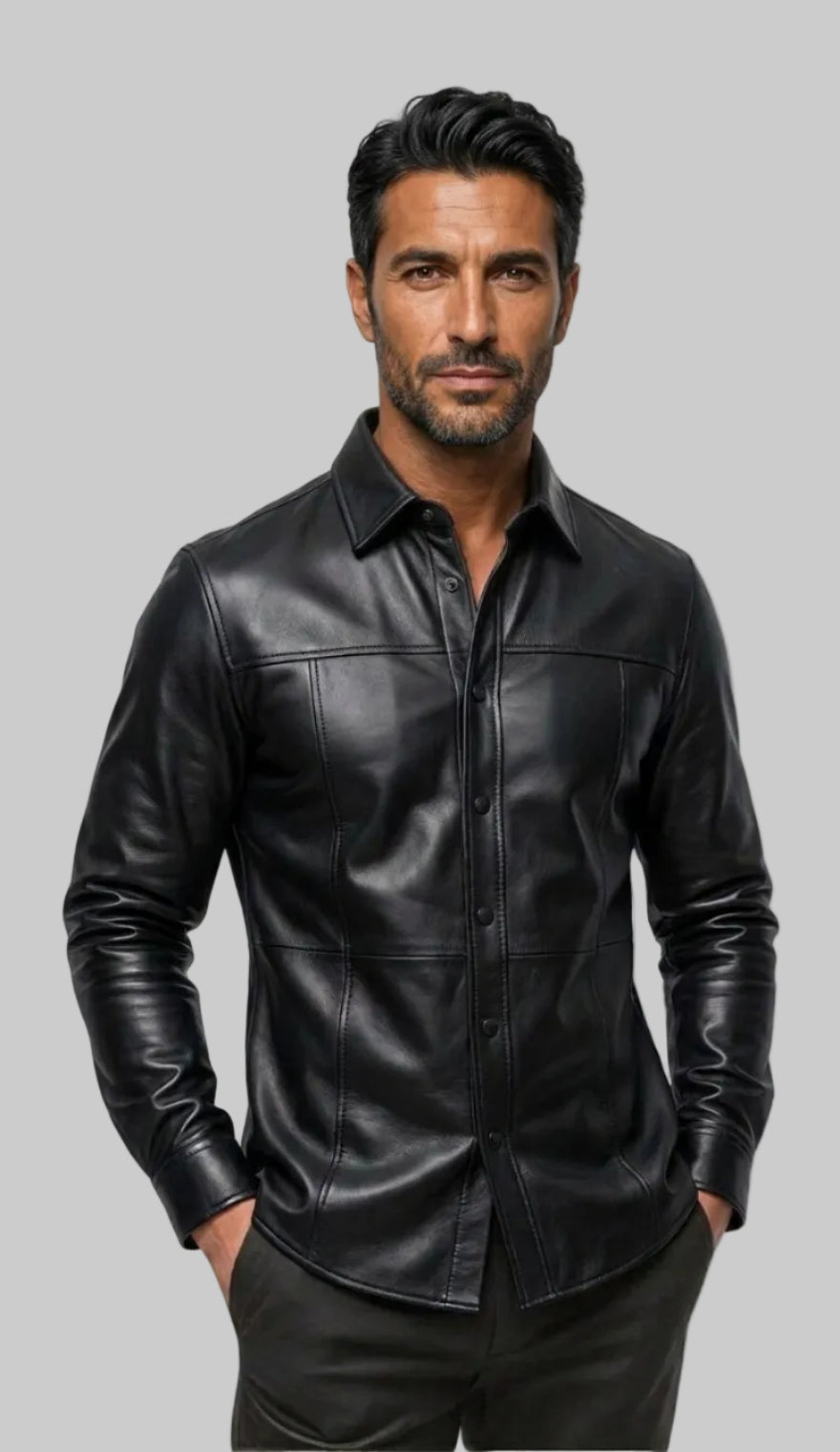 A man wearing our Black Custom Leather Shirt for Men with a collar , paired with dark trousers, photographed against a off white background.
