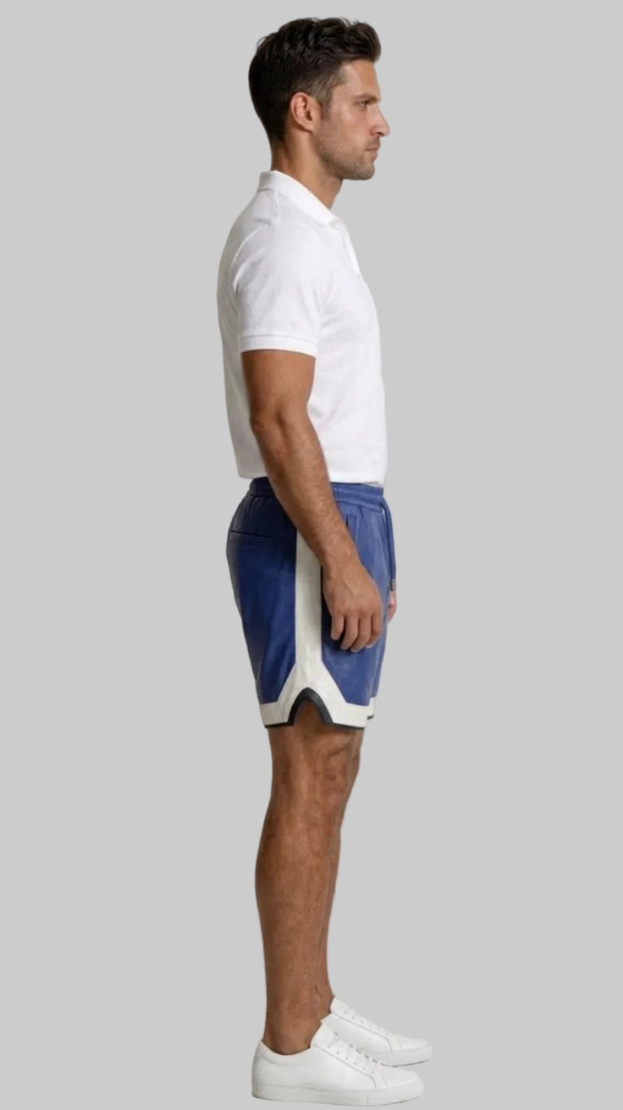 Man wearing a white polo shirt and our Blue Mens Leather Shorts with Contrast Side Stripe  against a white wall, side view.