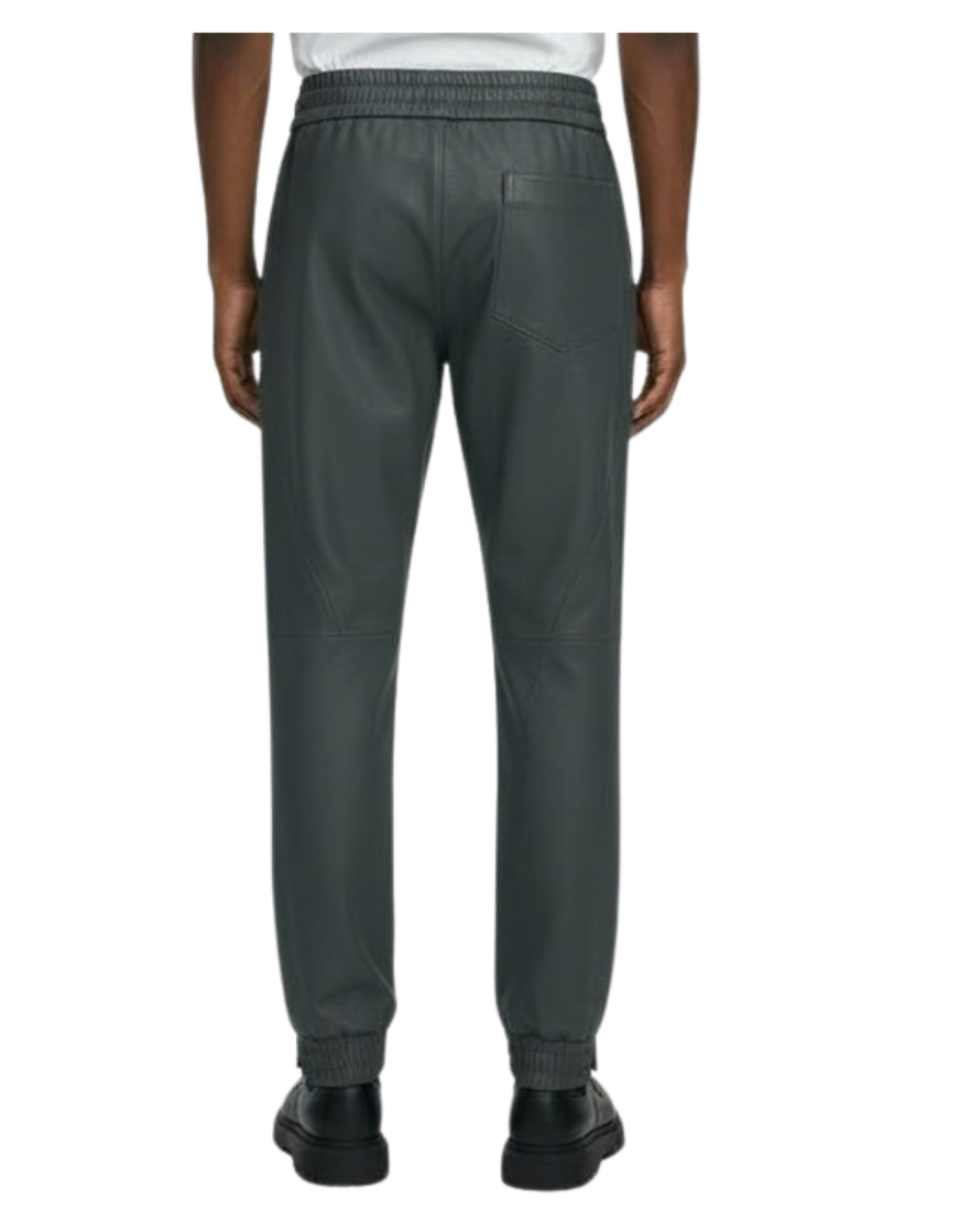 Our grey leather joggers worn by a person on a white background