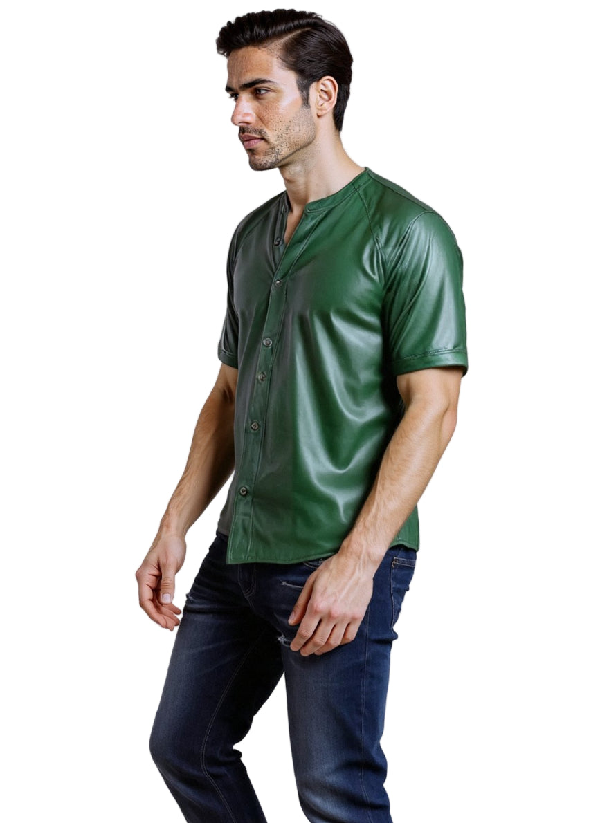 Man wearing a green button-up leather shirt and dark jeans on a white background, side view.