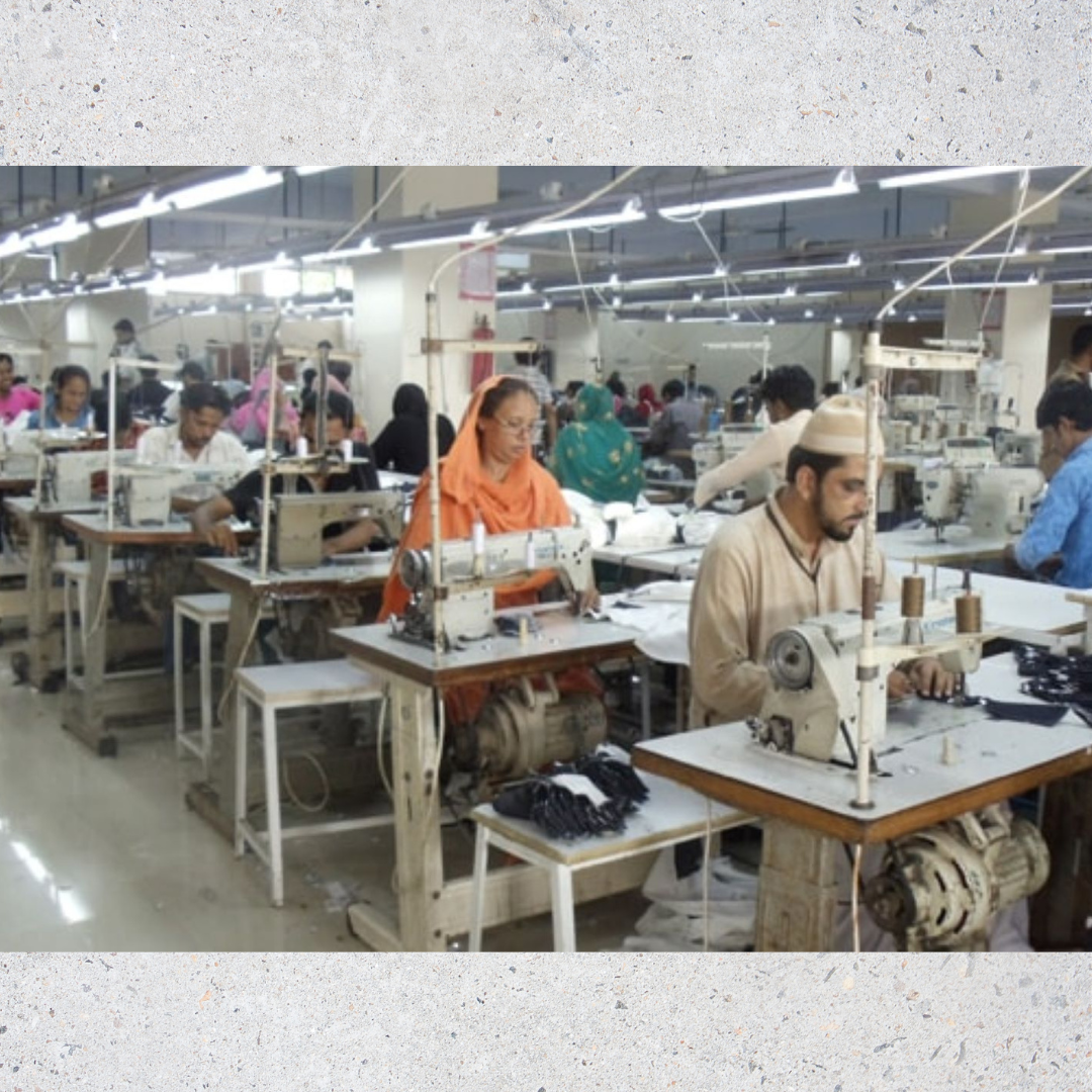 Picture of our factory floor showing several employees working at sewing machines