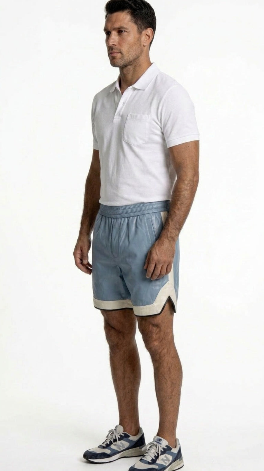Man wearing a white polo shirt and  our light blue leather shorts on a white background, Side view.