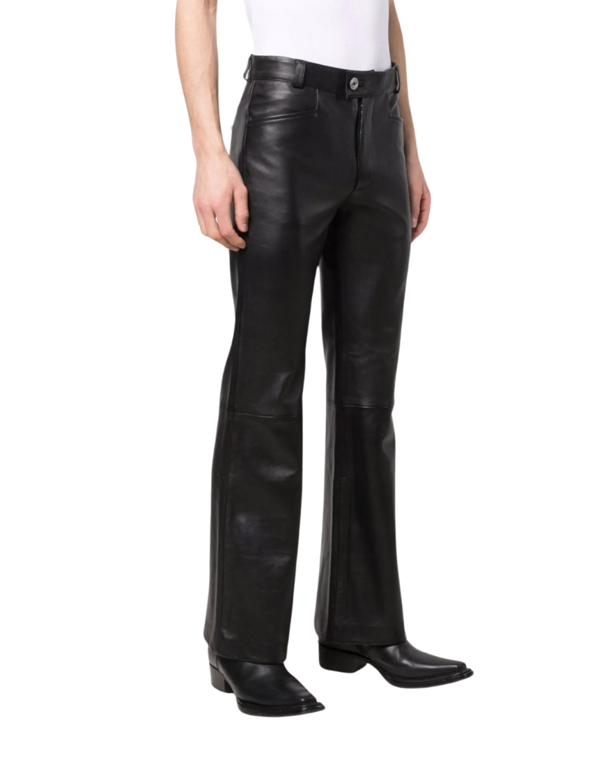 Picture of a model wearing our Mens Black Flared Leather Pants, side view.