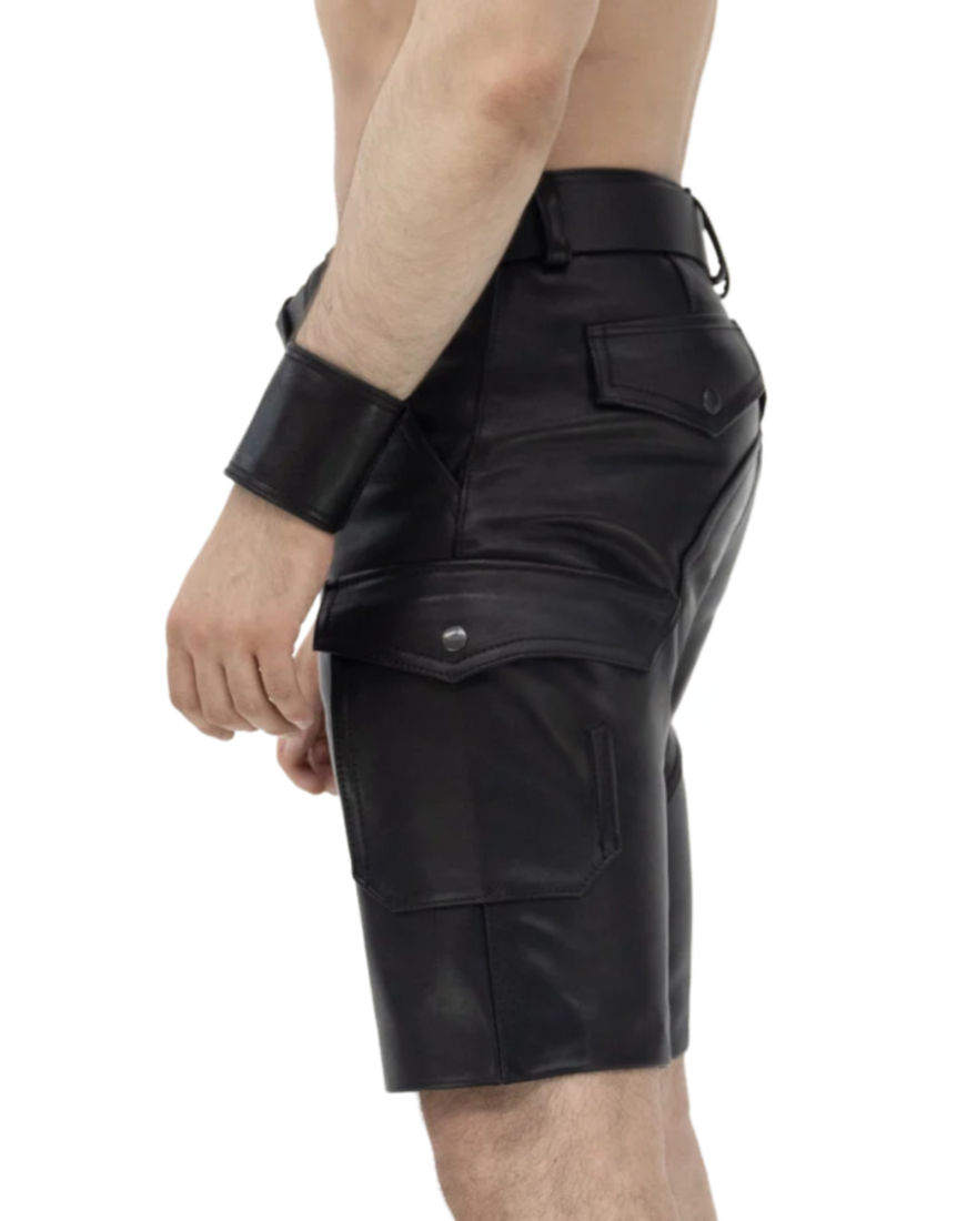 Picture of a model wearing our Mens Black Leather Cargo Shorts, side view.