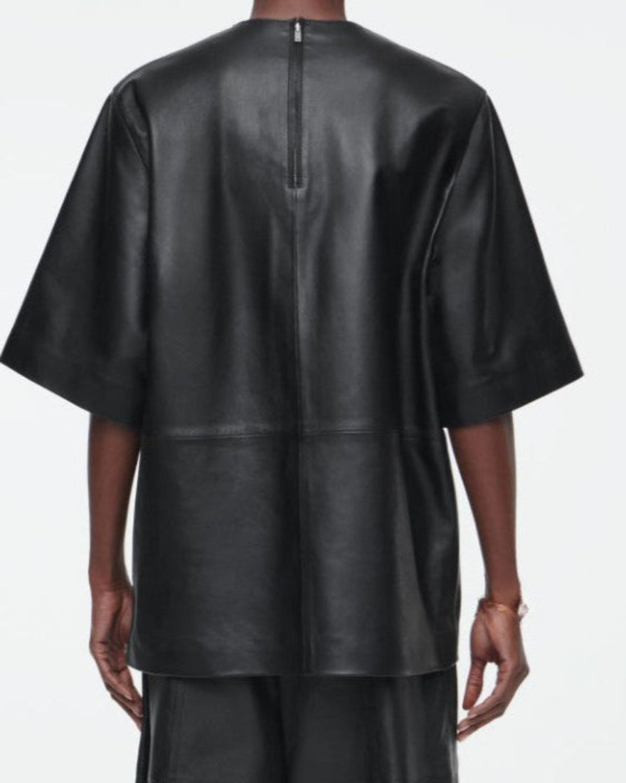 Picture a model wearing our black leather T Shirt, back view.