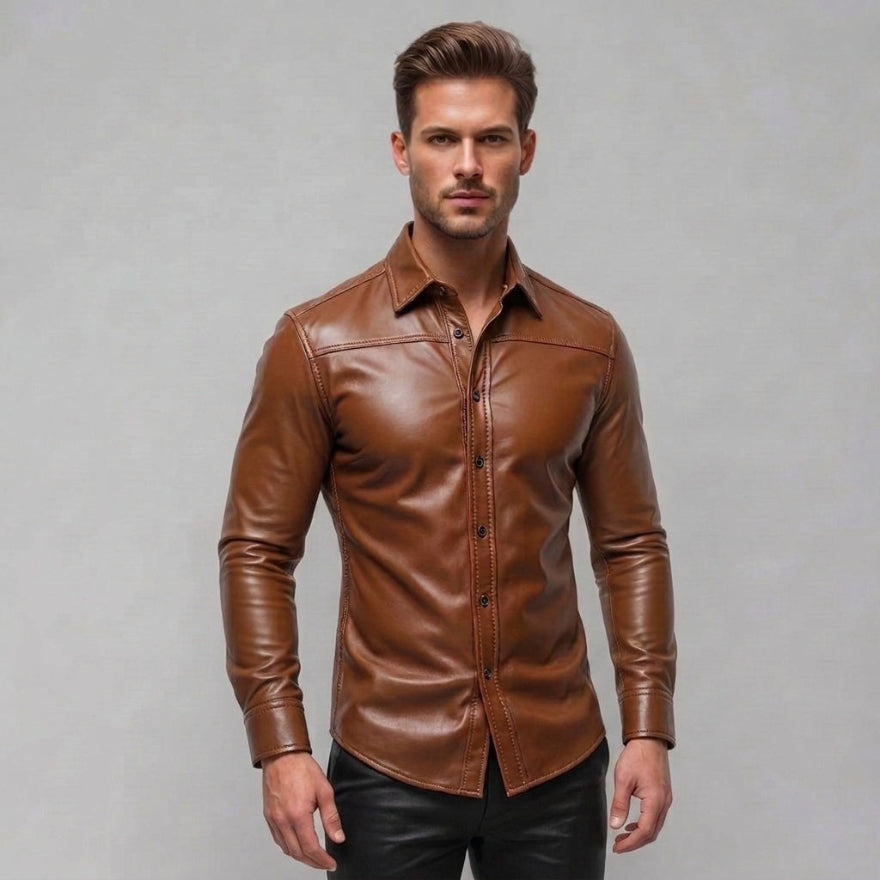 A man wearing our long-sleeve tan  leather button-up shirt and black pants, standing against a neutral gray studio background, front view.