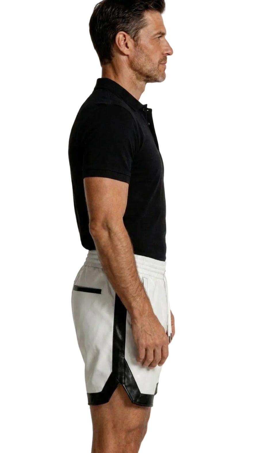 Man wearing a black cotton polo shirt and our white leather shorts with black contrast trim on a white background, side view.