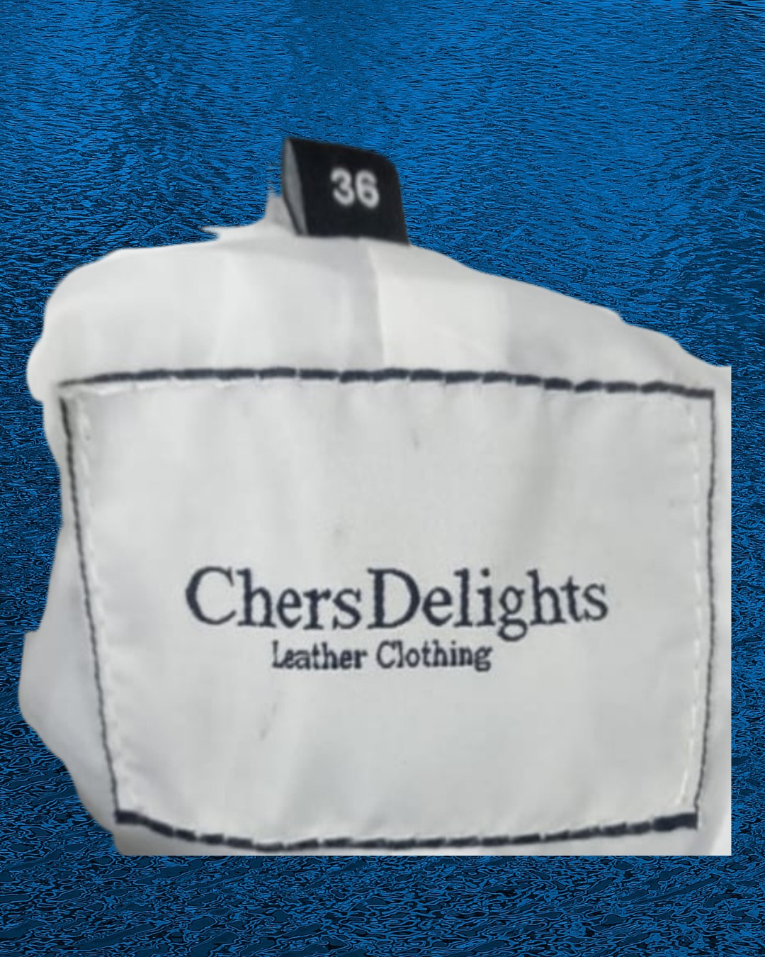 Picture of or ChersDelights Leather Brand label sewn inside the white leather pants/