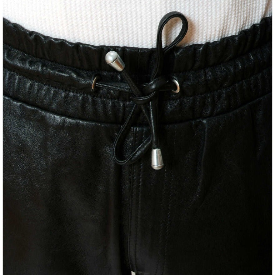 Picture of a model wearing our Mens Black Leather Shorts, close up view of the elastic waistband.