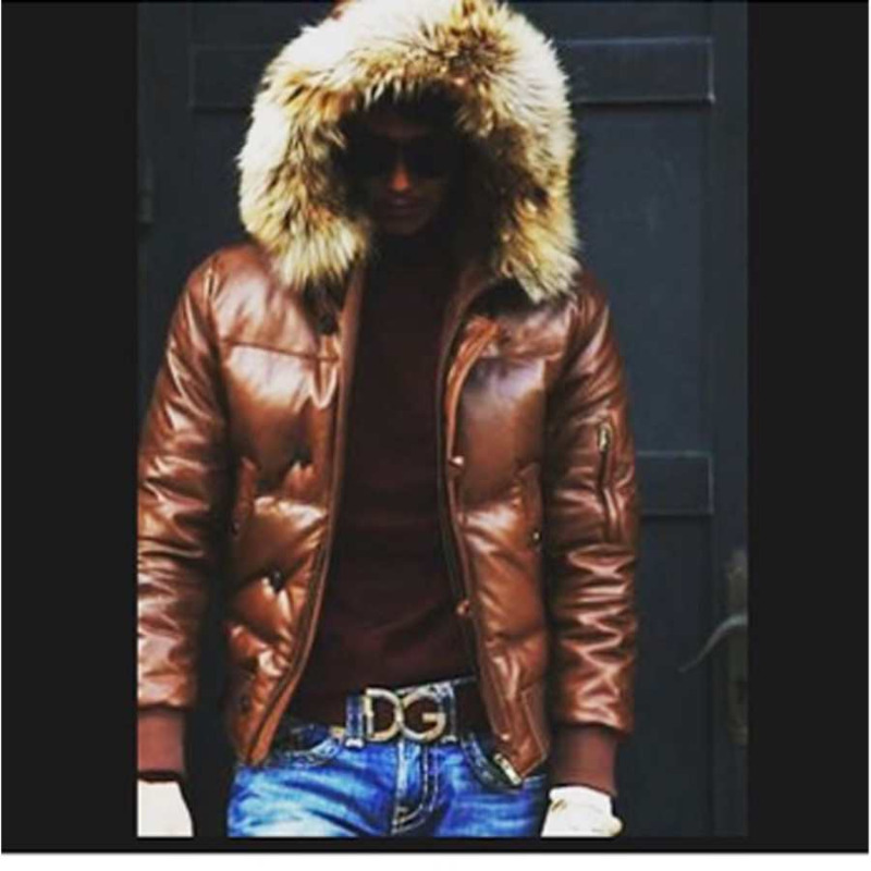 Picture of a model wearing our Brown Puffer Leather Jacket, front view with fur trimmed hood up and zipper open