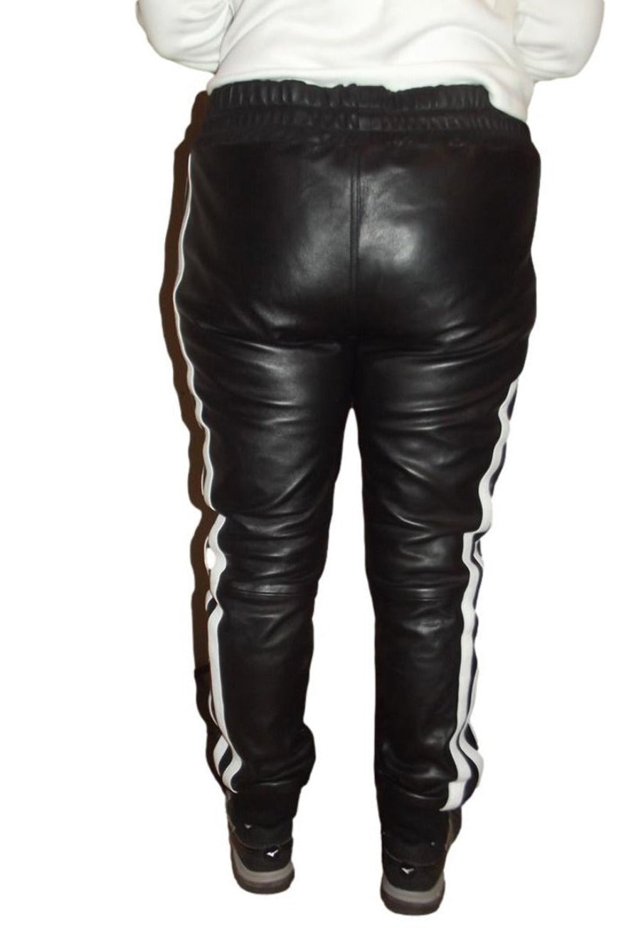 Picture of model wearing our Mens Black Leather Jogging Pants with 3 wide white stripes on outside of leg, back view.